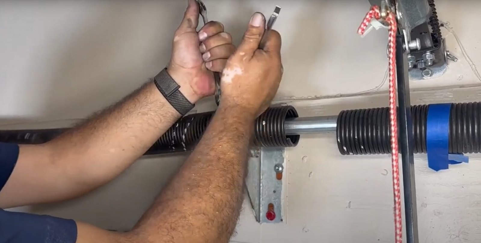 Professional technician performing garage door spring repair in Holmes Beach