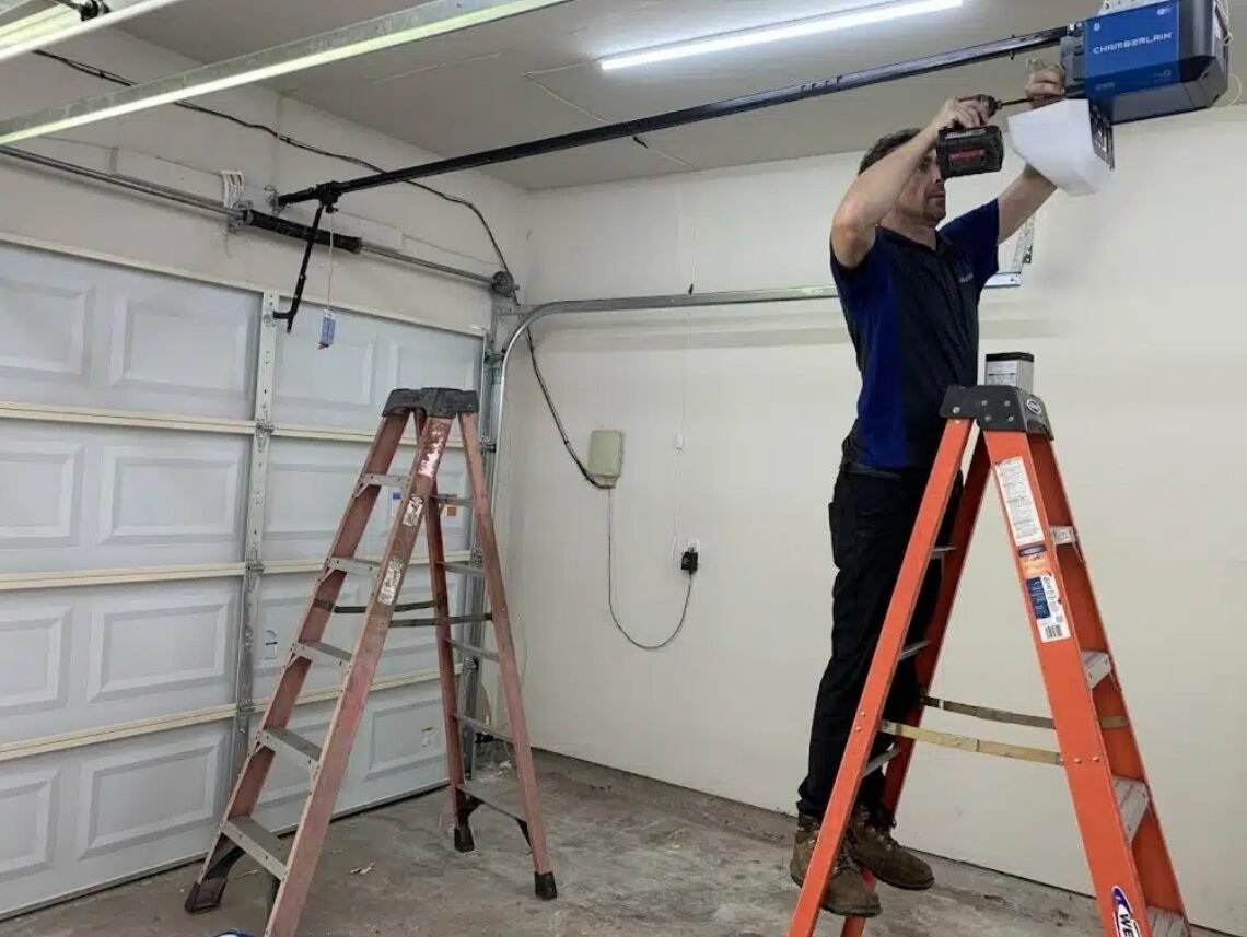 Professional technician performing garage door opener repair at a residential home in Holmes Beach.