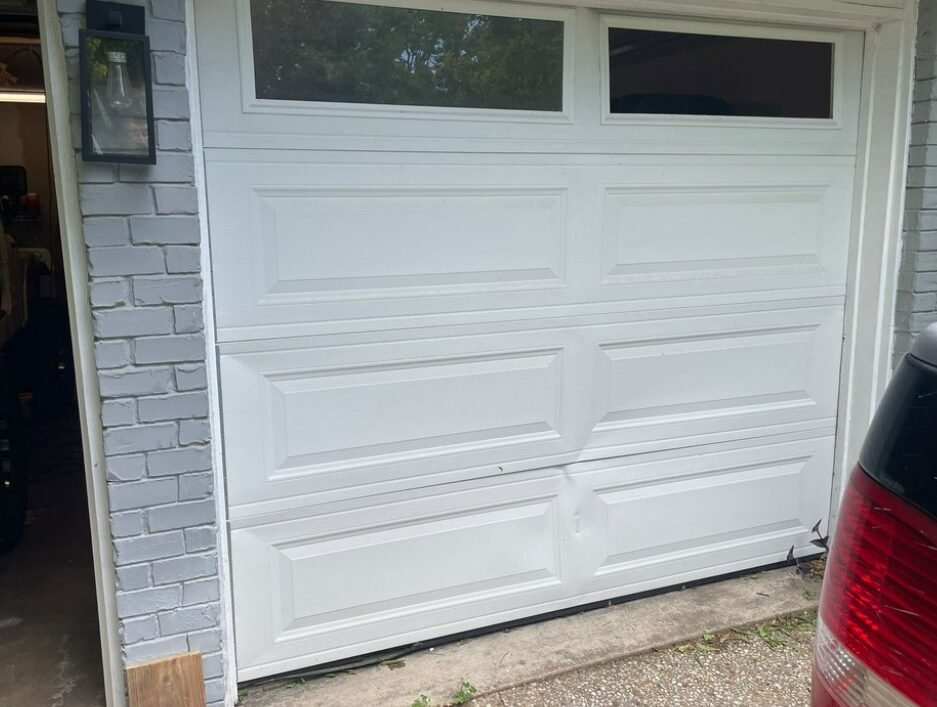 Professional technician performing garage door repair in Holmes Beach, ensuring safe and efficient operation of residential garage doors.