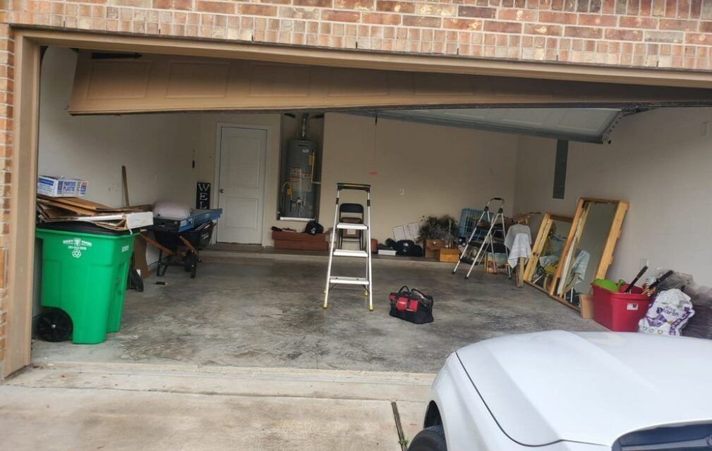 Technician performing garage door repair service in Holmes Beach, FL, ensuring smooth and safe operation of residential garage doors.